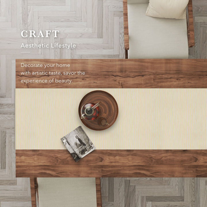 Wooden dining table with decorative items on a herringbone floor.