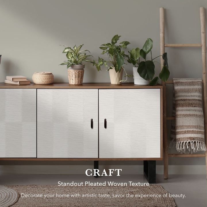 White cabinet with pleated woven texture in a room with plants and a ladder.