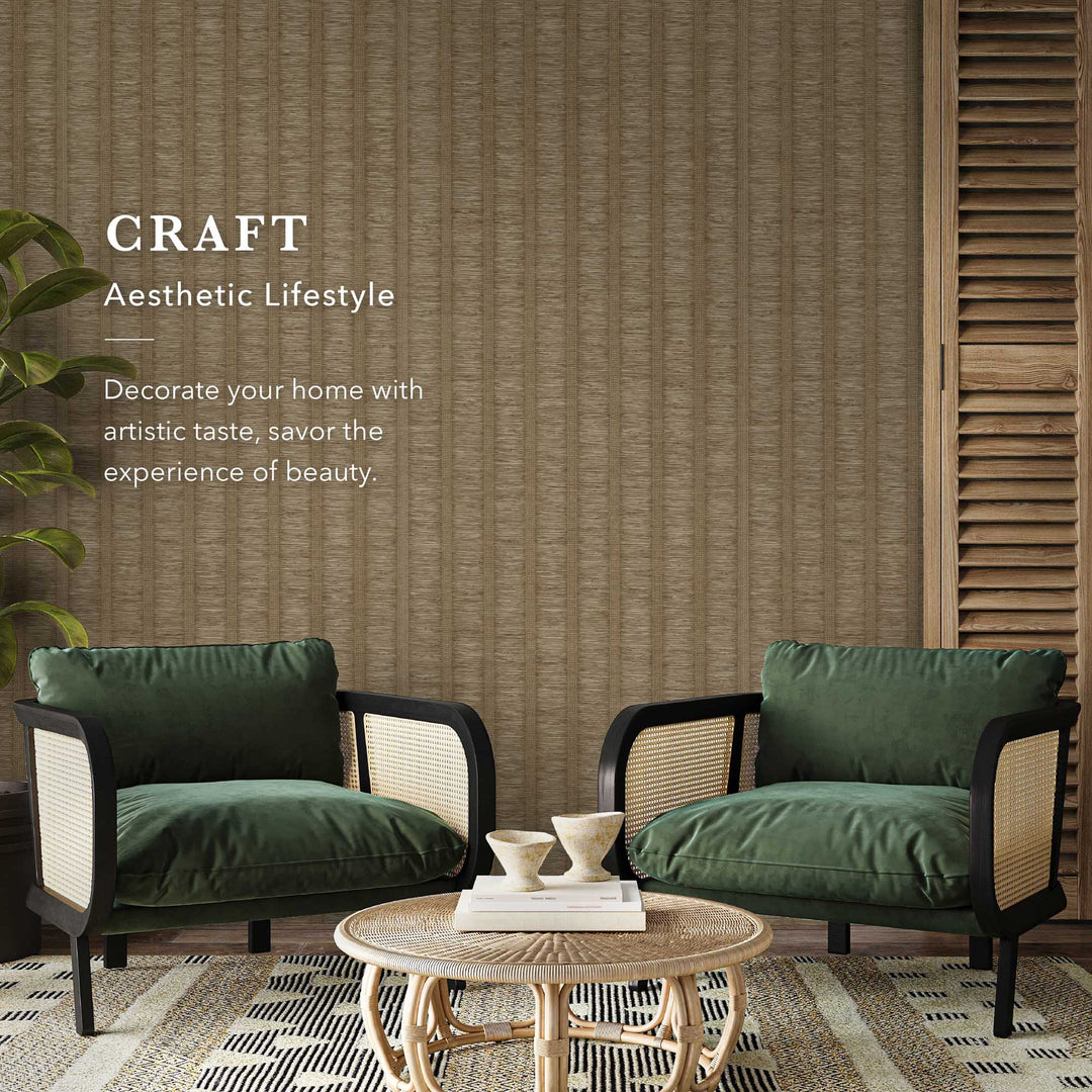 Modern living room with brown textured vertical stripe wallpaper, green velvet rattan armchairs, a round woven coffee table, and a decorative text accent.