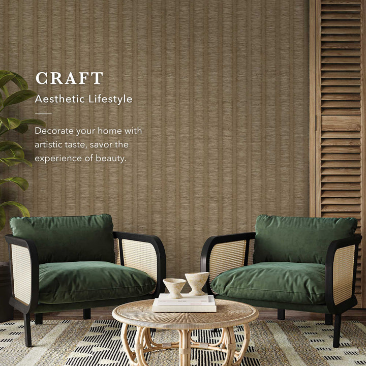 Modern living room with brown textured vertical stripe wallpaper, green velvet rattan armchairs, a round woven coffee table, and a decorative text accent.