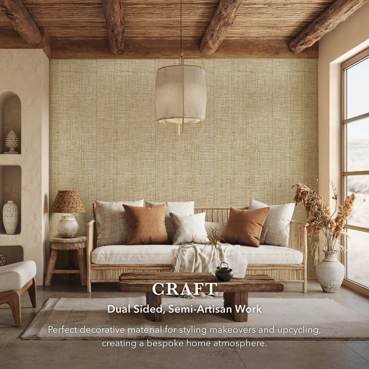 Rustic living room interior with beige textured wallpaper, rattan sofa, earthy toned cushions, wooden coffee table, and text overlay highlighting dual sided semi-artisan decorative fabric.