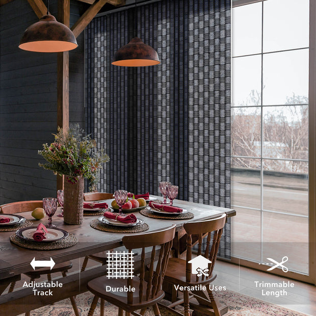 Dining room with a large window, wooden table, and chairs, featuring adjustable track curtains.