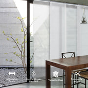 Modern interior with a dining table and chairs, featuring adjustable track blinds.