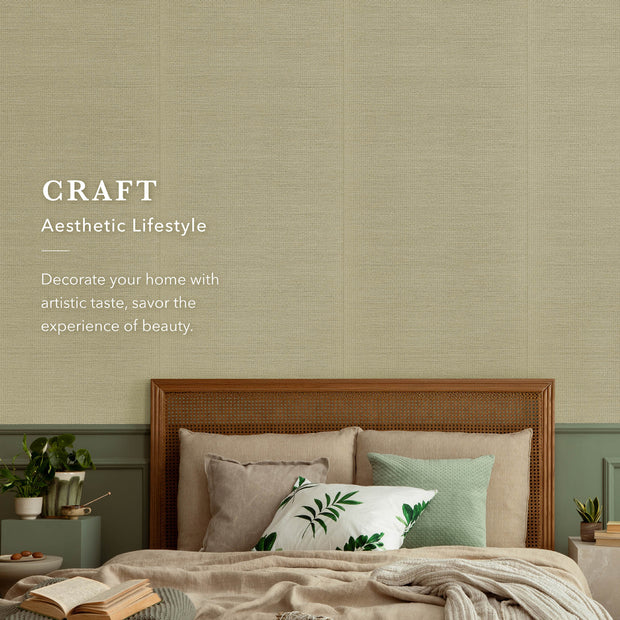Cozy bedroom with beige textured wall, wooden rattan headboard, neutral bedding, and green accent pillows.