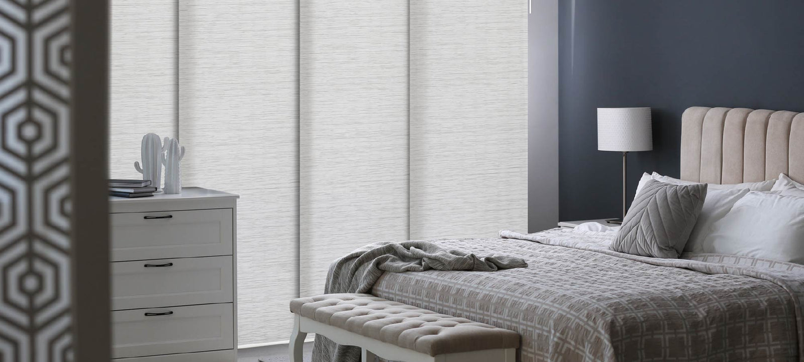 Mica semi-sheer panel blinds in a calm bedroom setting, featuring soft gray streaks that add quiet texture. Paired with tufted headboard and muted tones for a serene, modern retreat.