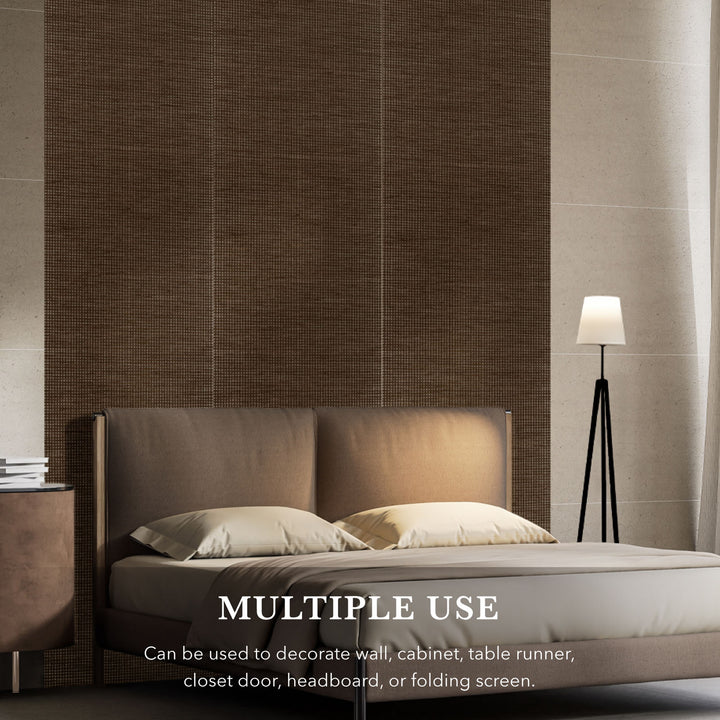 Bedroom setting with a bed and lamp against a textured wall.