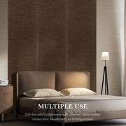Bedroom setting with a bed and lamp against a textured wall.