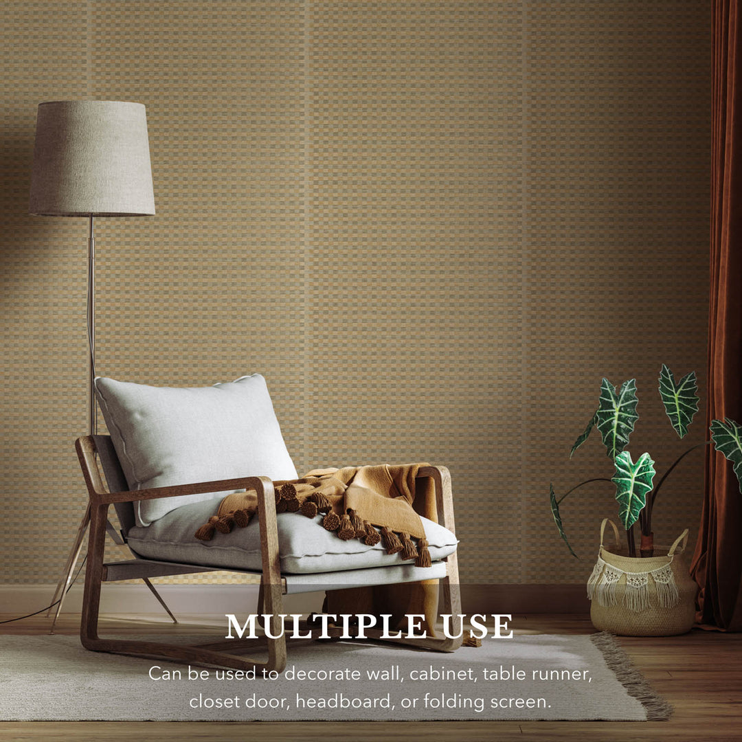 Living room with wooden chair, lamp, and plants against a textured wall.