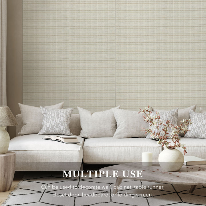 Light gray textured wall paper with a sofa and decor elements in a room setting.