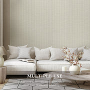 Light gray textured wall paper with a sofa and decor elements in a room setting.