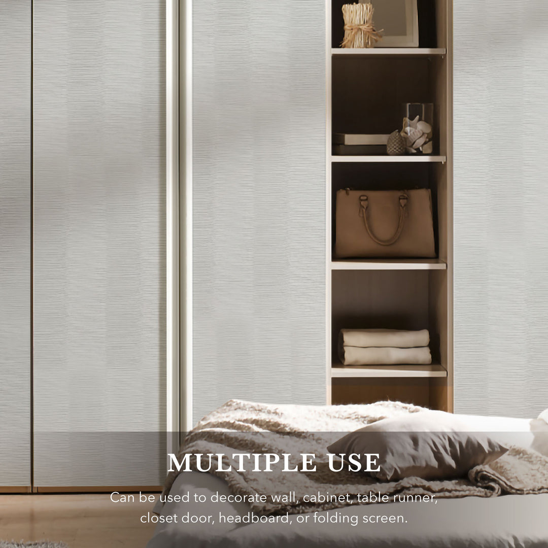 Bedroom setting with a bed and wooden shelf against a textured wall.