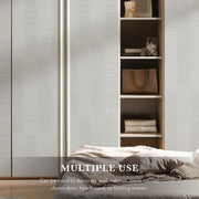 Bedroom setting with a bed and wooden shelf against a textured wall.