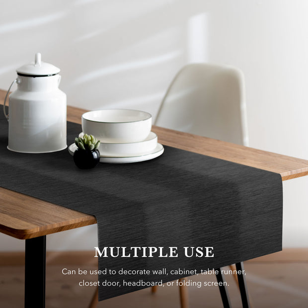 Black table runner on a wooden table with white decor items, text indicating multiple uses.