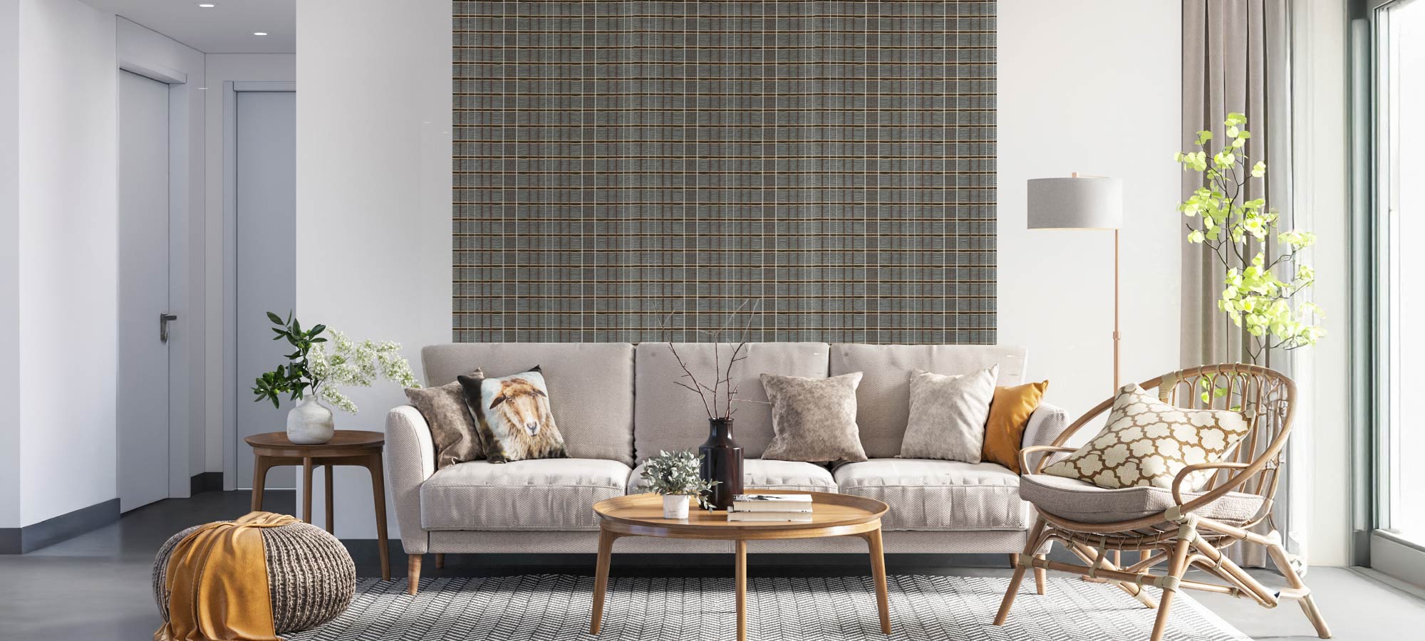 Bright living room with a neutral sofa, patterned cushions, rattan chair, round wooden coffee table, and gray plaid textured wallpaper.