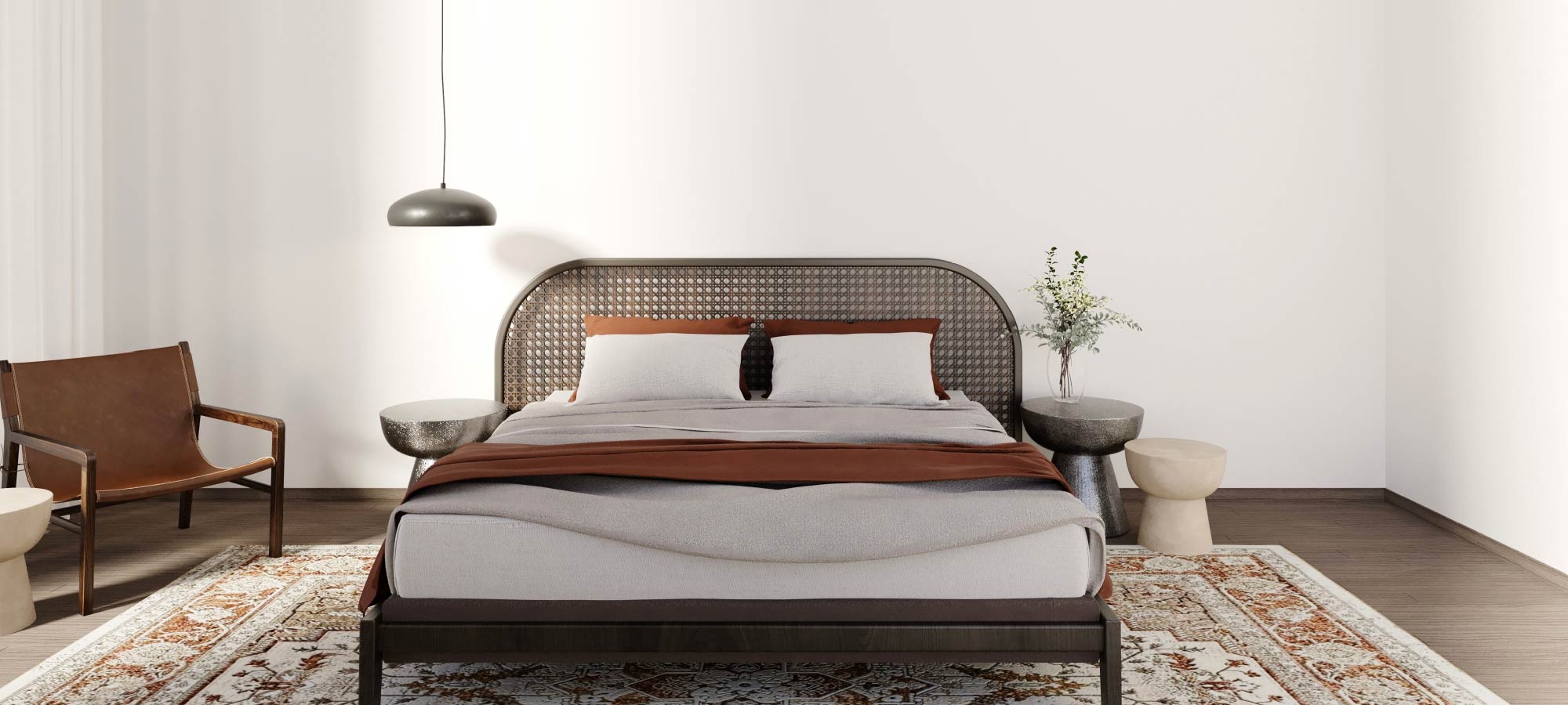 Minimalist bedroom featuring a woven rattan headboard, neutral bedding with warm brown accents, modern pendant lighting, and an oriental patterned rug for a cozy contemporary style.