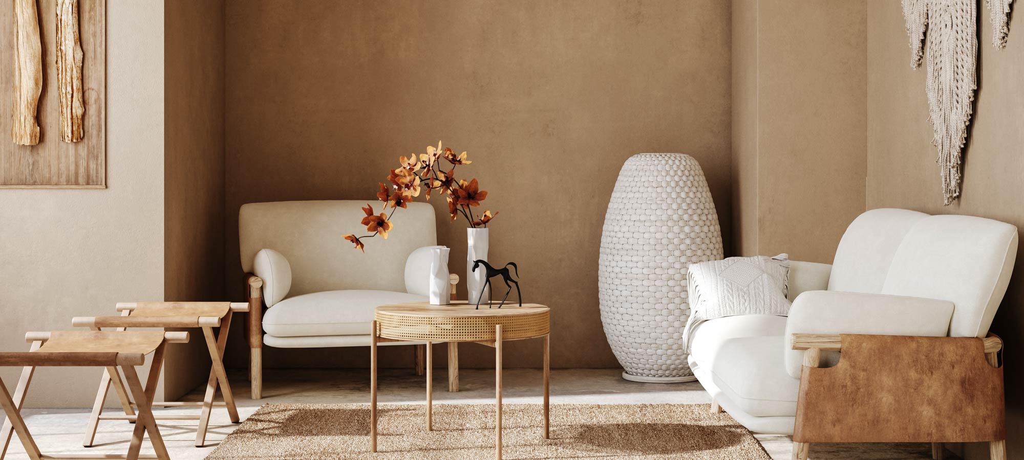 Modern living room with white sofa, armchair, and coffee table against a beige wall.
