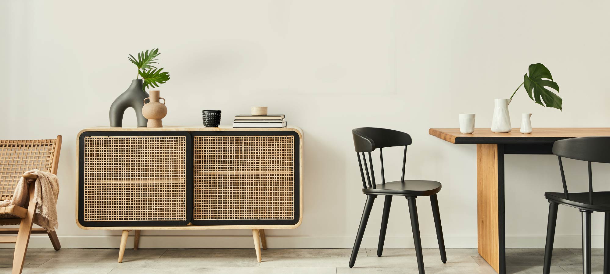 Scandinavian-inspired interior with natural woven furniture and minimalist black seating.