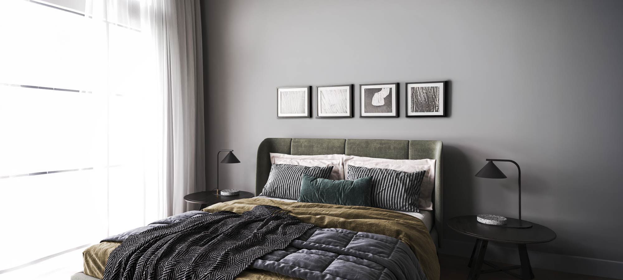 Modern bedroom with gray walls, green upholstered headboard, striped pillows, layered blankets, and minimalist nightstands.