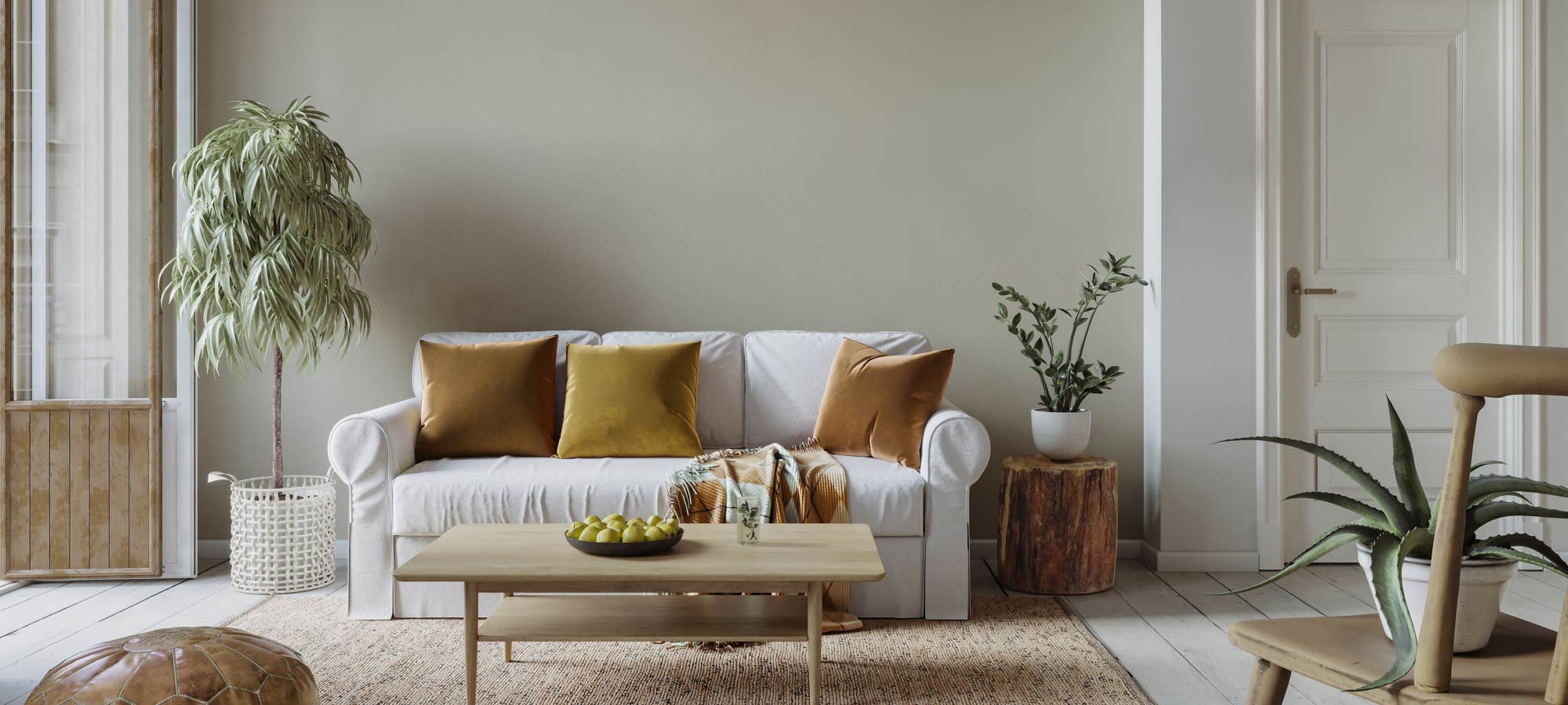Scandinavian style living room with white sofa, mustard throw pillows, wooden coffee table, indoor plants, and natural light.