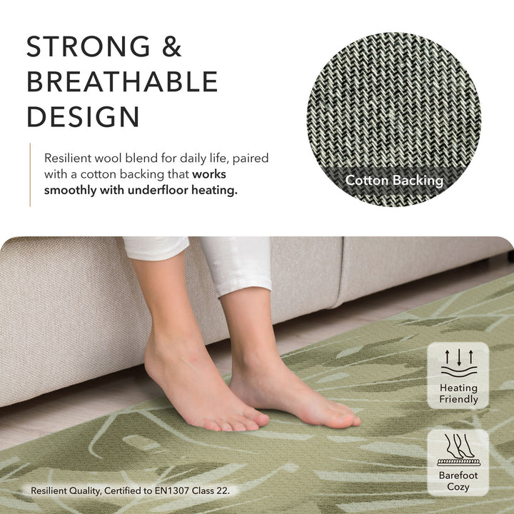 Green rug on a floor with text about its strong and breathable design, cotton backing, and suitability for underfloor heating.