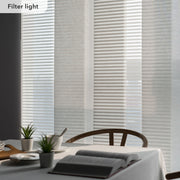 Light filtering blinds in a room with a table and plants