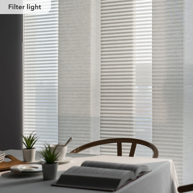 Light filtering blinds in a room with a table and plants