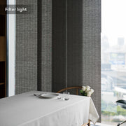 GoDear Design Dining table with white tablecloth, plates, and glasses against a textured gray wall.
