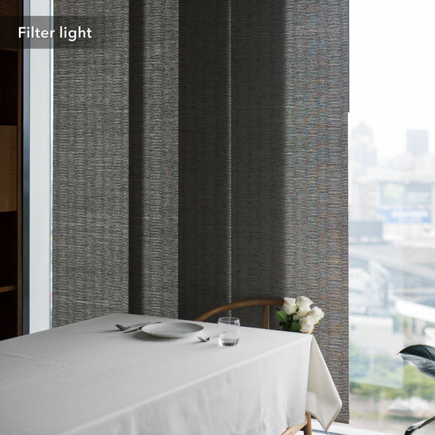 GoDear Design Dining table with white tablecloth, plates, and glasses against a textured gray wall.