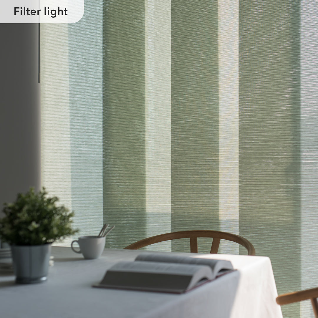 Table setting with a book and cup against a striped green and beige wall.