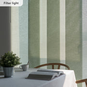 Table setting with a book and cup against a striped green and beige wall.