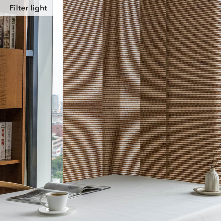 GoDear Window with woven wood blinds filtering light, bookshelf and table with items in the foreground