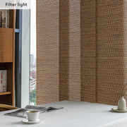 GoDear Window with woven wood blinds filtering light, bookshelf and table with items in the foreground