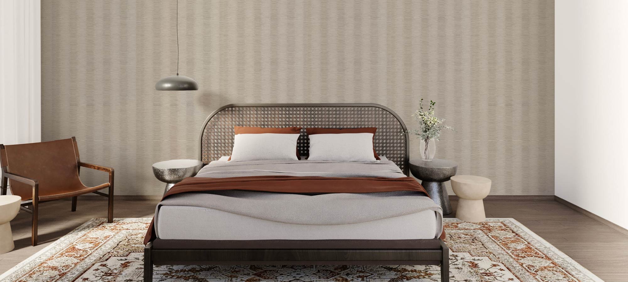 Contemporary bedroom with a woven rattan headboard, neutral bedding, brown leather accent chair, patterned rug, and textured feature wall adding depth and style.