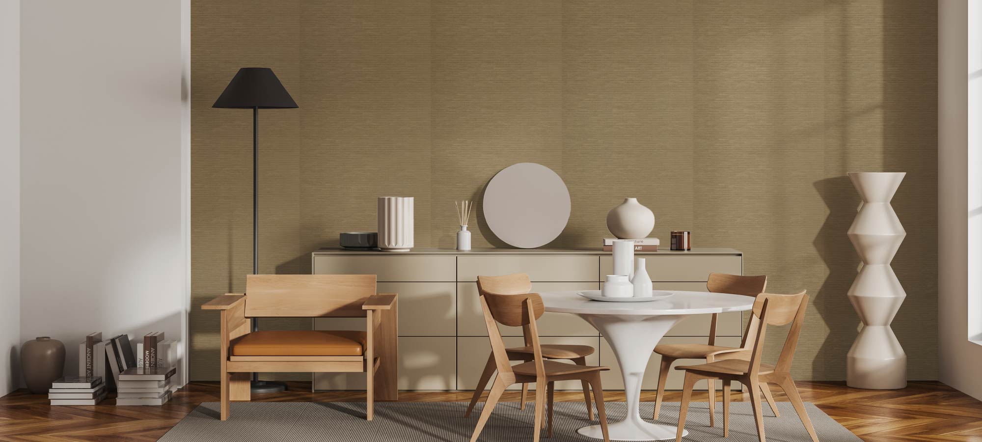 Modern dining room with a round white table, wooden chairs, minimalist sideboard, and textured beige wallpaper in warm natural light.