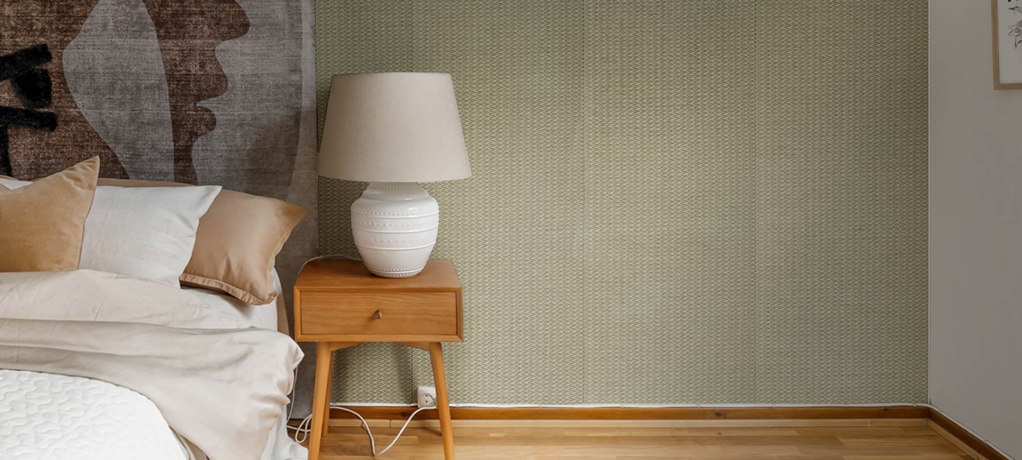Cozy bedroom corner featuring neutral bedding, abstract wall art, and minimalist décor.