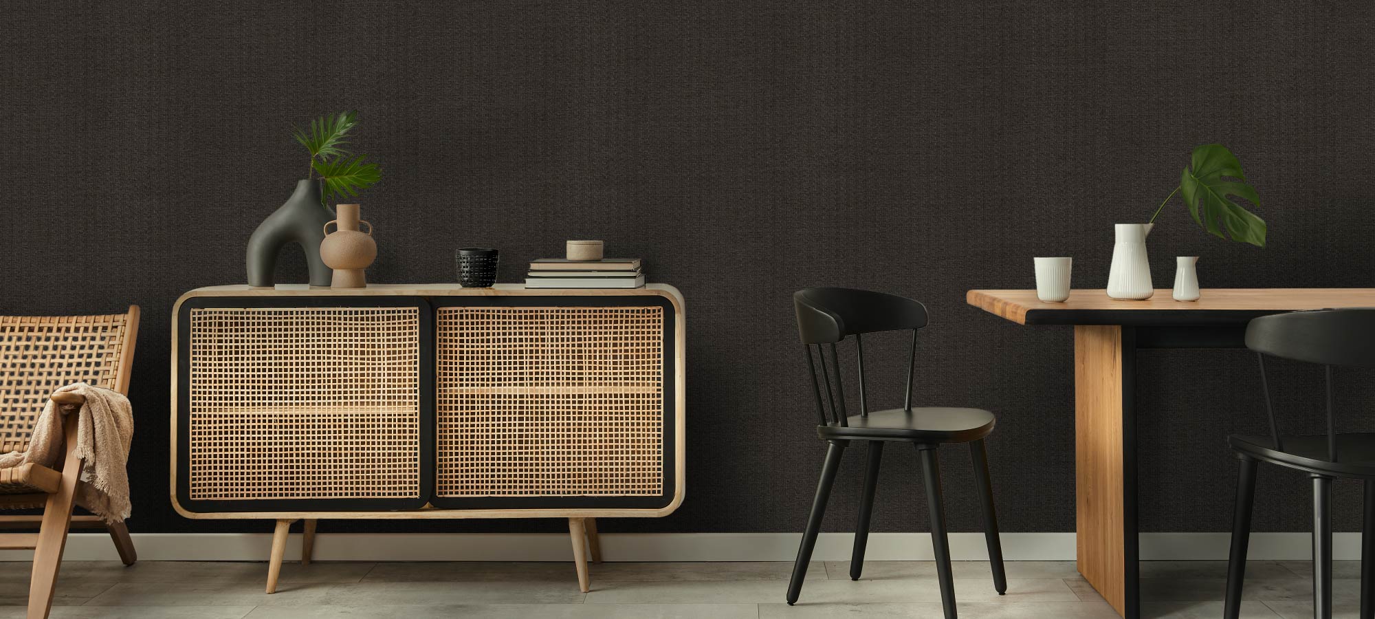 Modern interior design featuring natural wood furniture, woven textures, and dark backdrop.