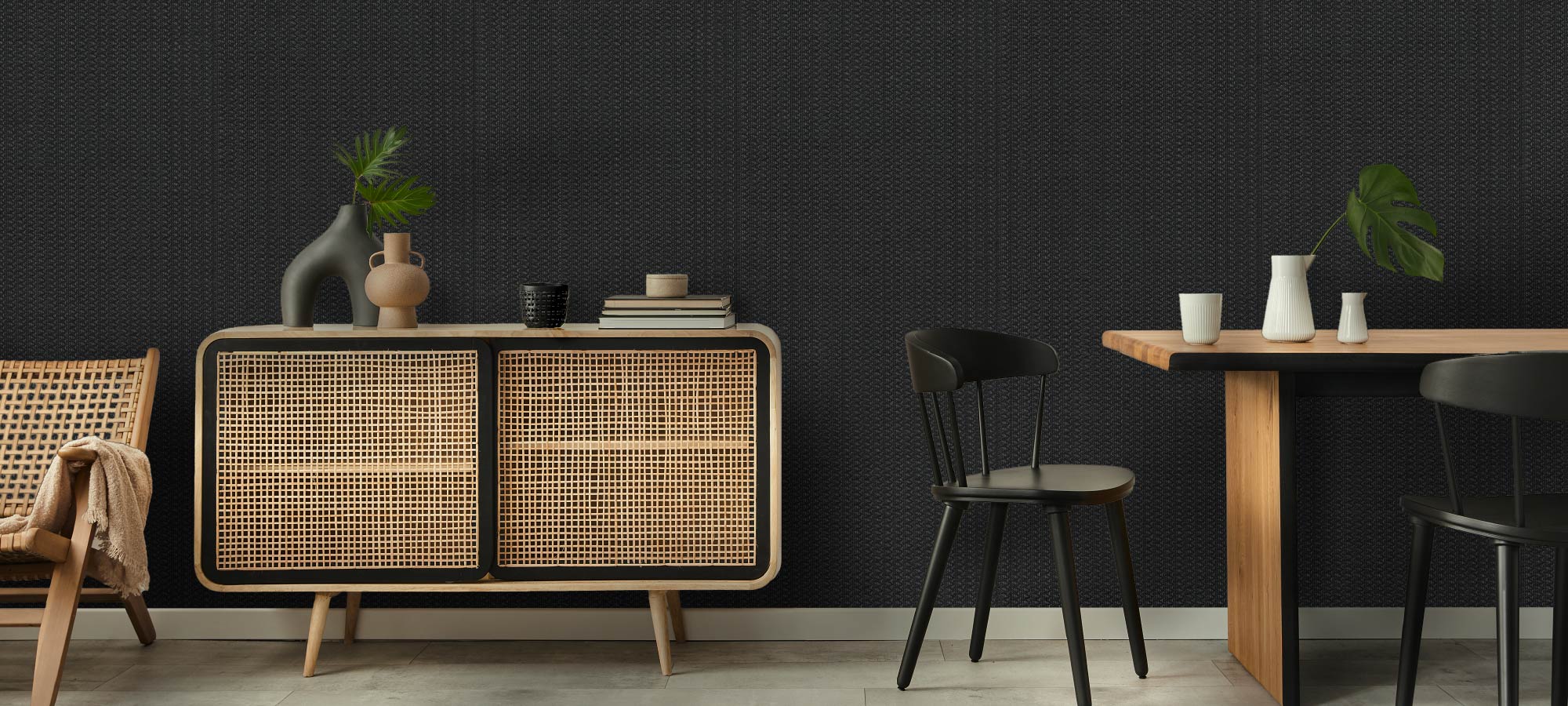 Contemporary dining area with woven rattan cabinet, black chairs, and minimalist décor.
