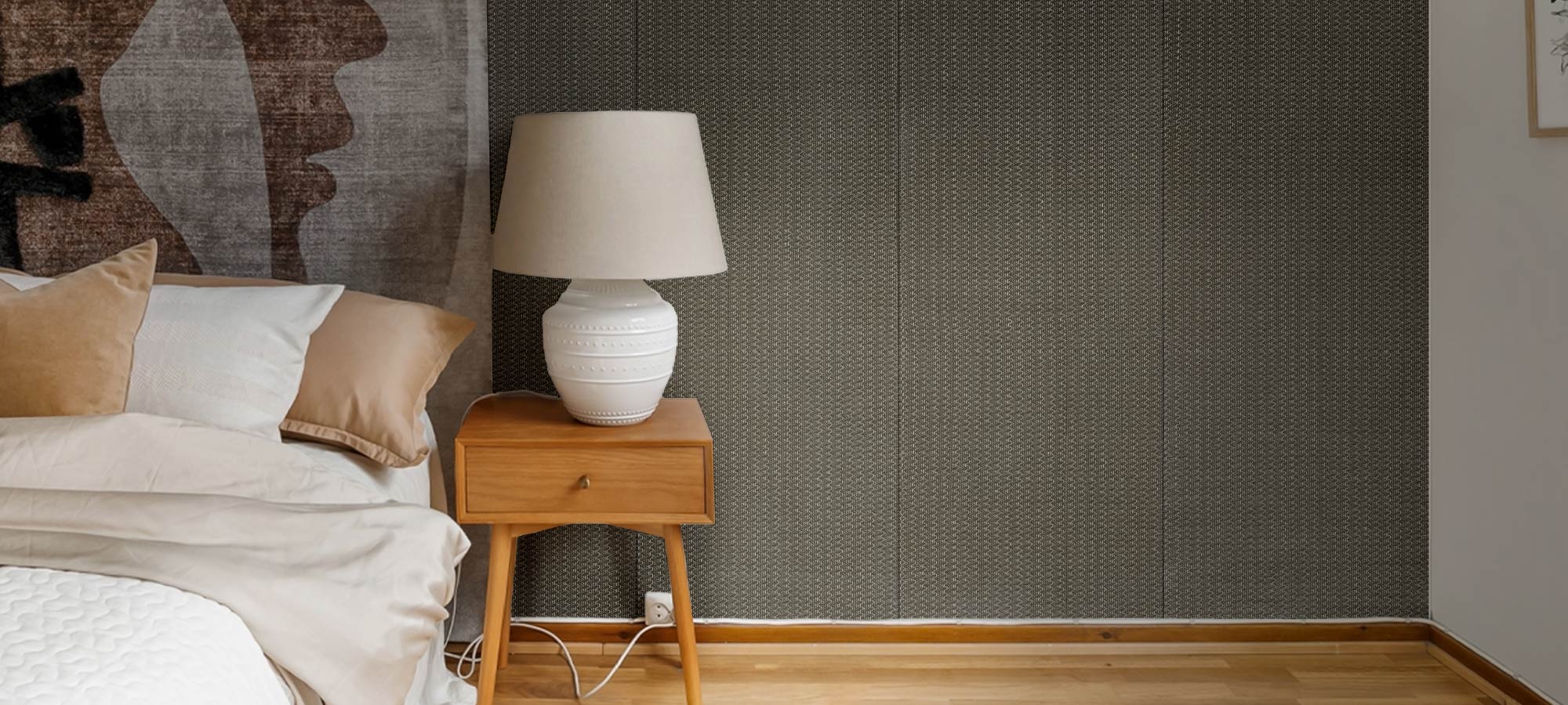 Bedroom with textured accent wall and wooden nightstand with ceramic lamp.