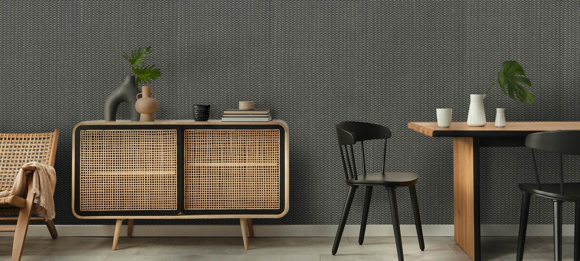 Modern home interior featuring rattan cabinet, black chairs, and minimalist decor.