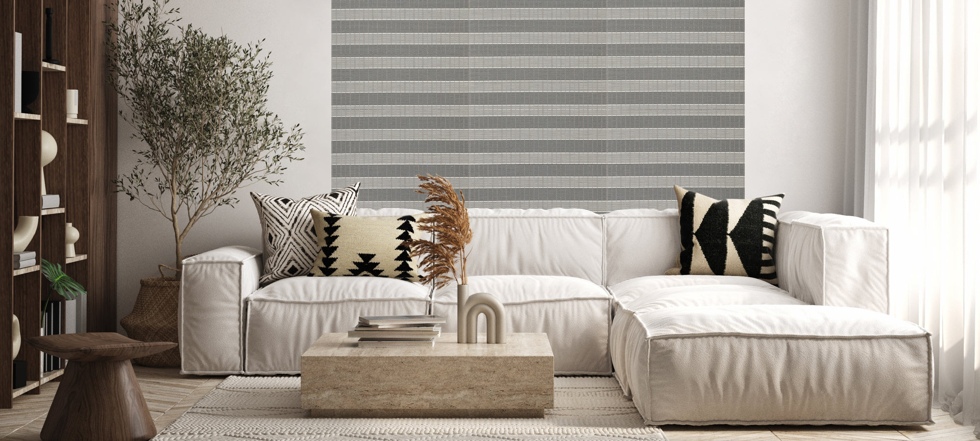 Contemporary living room with striped accent wall, white sectional sofa, geometric patterned pillows, and natural wood coffee table.
