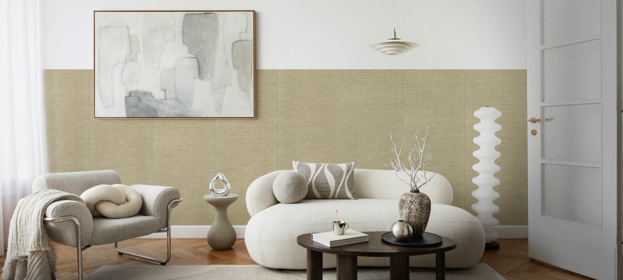 Modern living room with a white sofa, armchair, and abstract painting on a green wall.