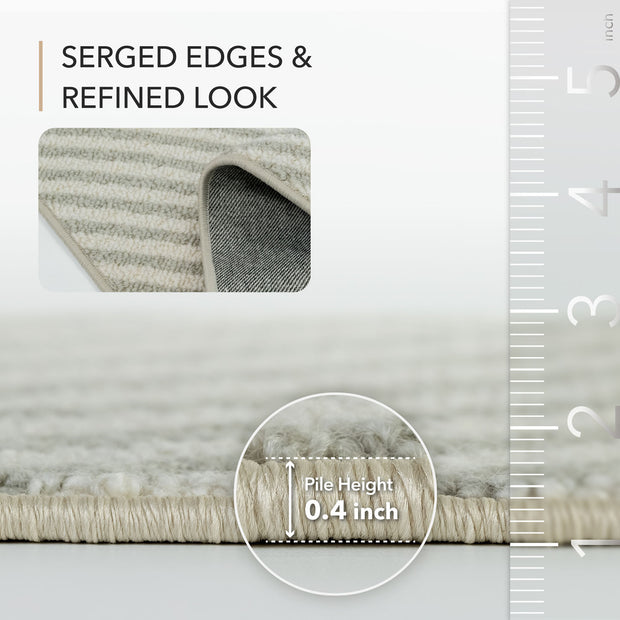 Gray rug with serged edges and refined look, showing pile height measurement.