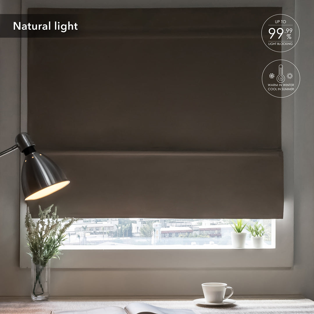 GoDear Design Window with dark roller blind, lamp, and plants on a table.