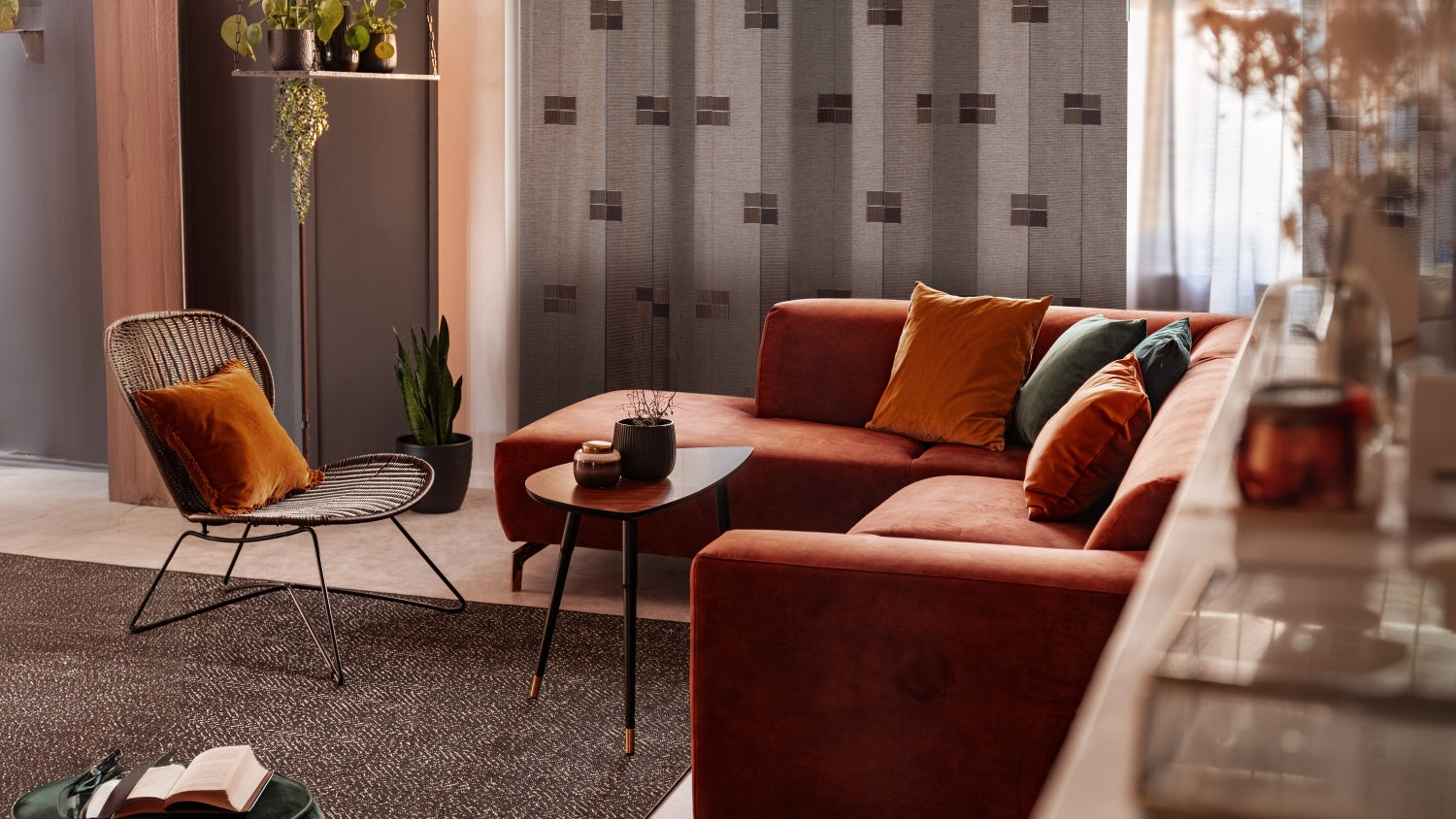 Living room with a red sofa, armchair, sliding panel blinds and coffee table.