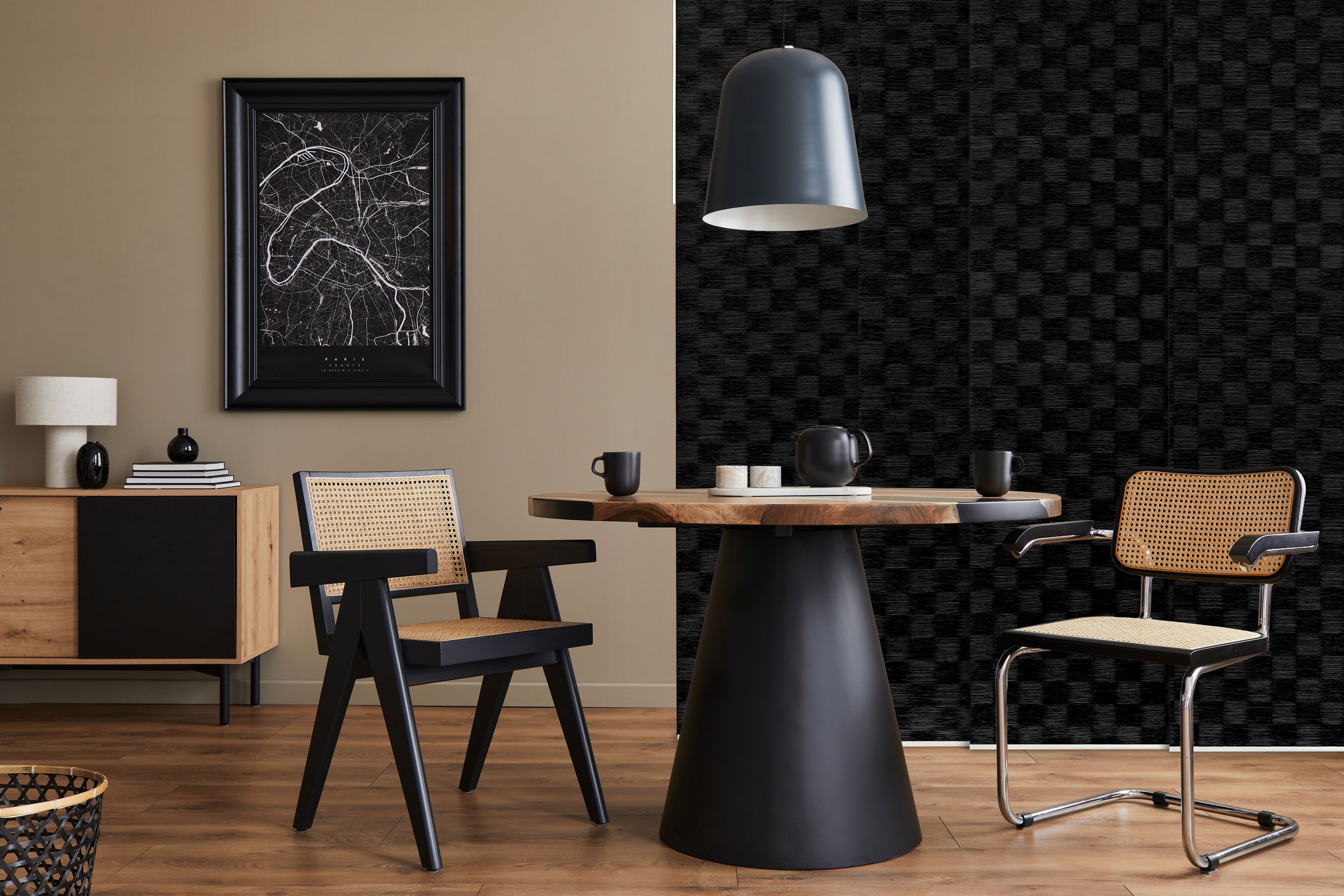 GoDear Design_Modern interior with a round wooden table and chairs against a black and white patterned wall.