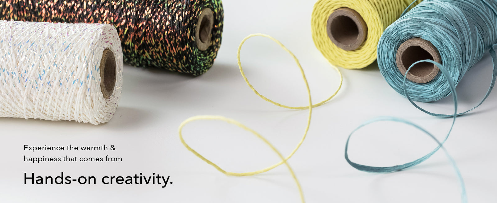 GoDear Colorful yarn rolls on a light background with text about hands-on creativity.