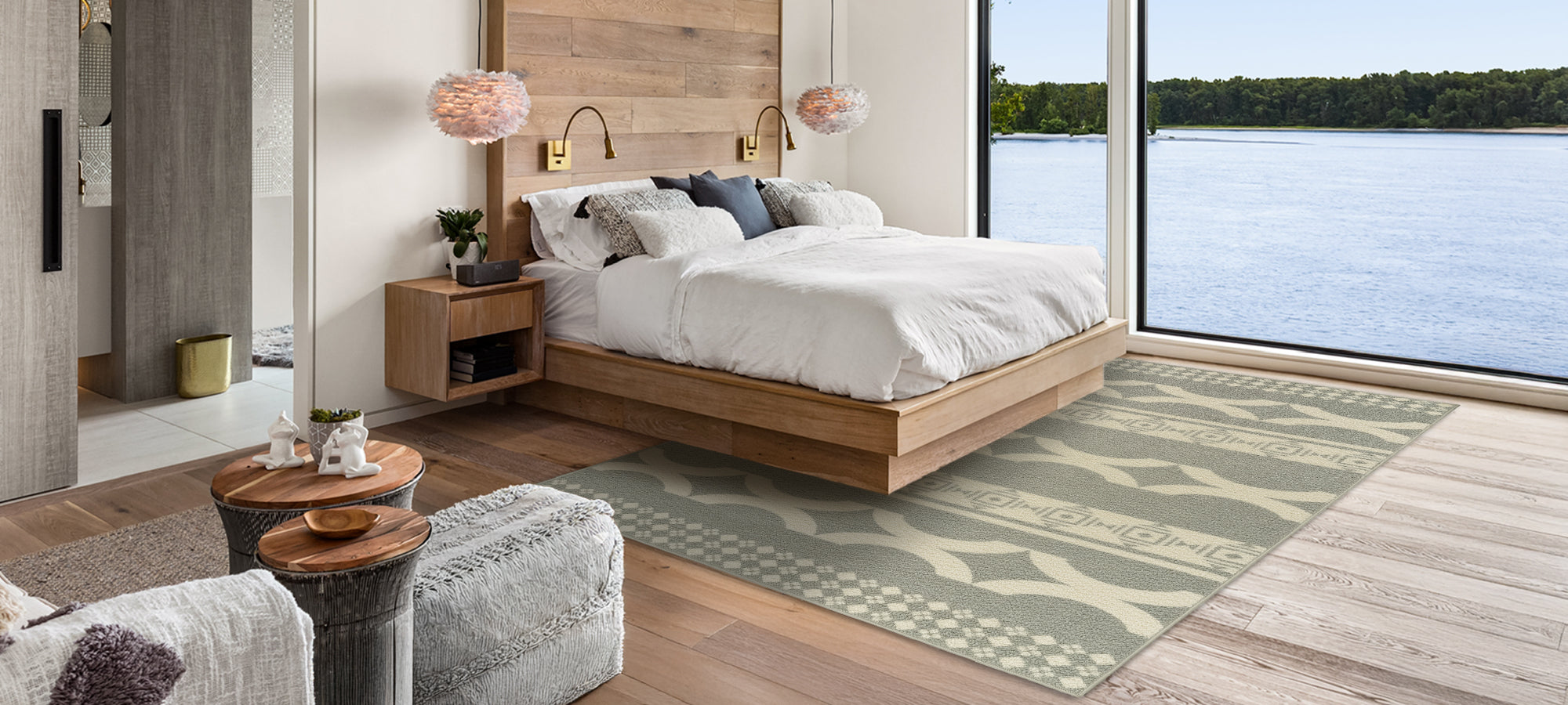 Modern bedroom with wooden bed, nightstands, and a large window overlooking water.