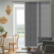 Modern living room with gray curtains, wooden chairs, and a coffee table.