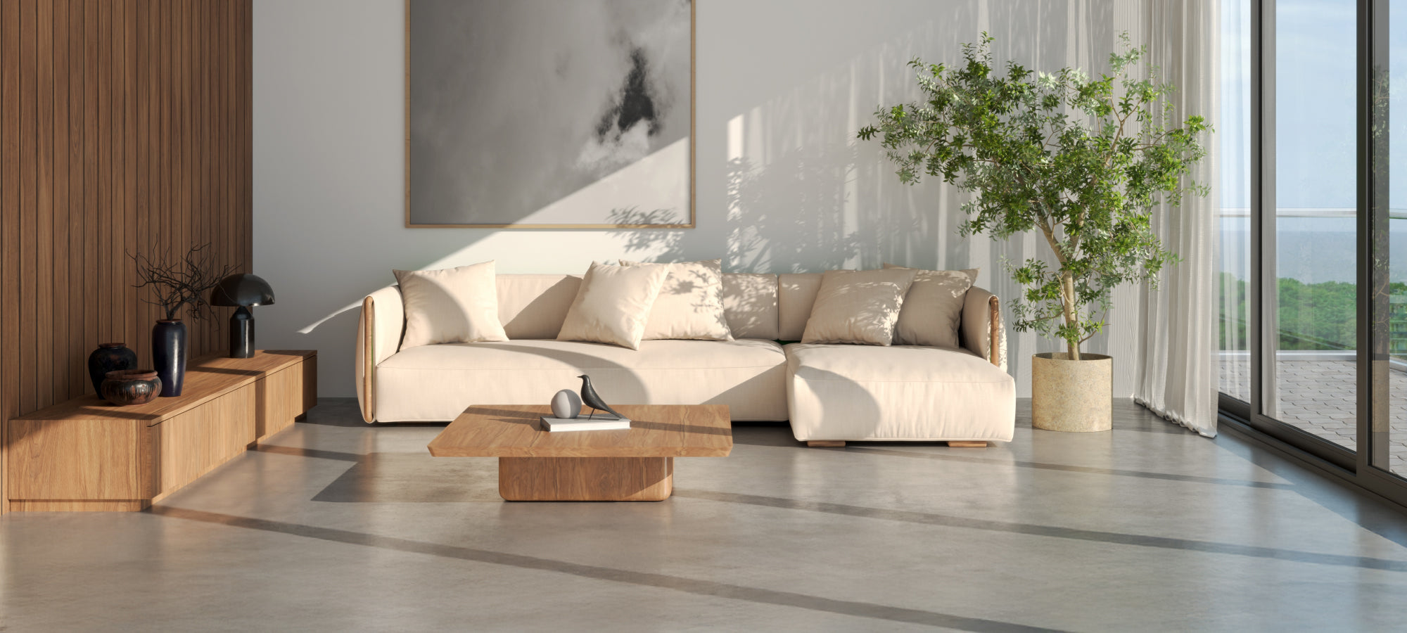 Living space featuring a white sofa, plants, and wooden accents, pictured before the Palm Fronds area rug was added. Bare flooring highlights the original acoustic and visual tone of the room.